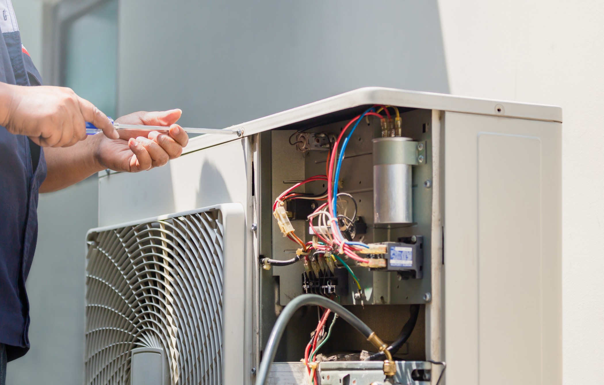 technician fixing hvac system